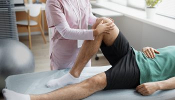 doctor-helping-patient-rehabilitation (1)